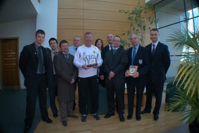 SIR ALEX FERGUSON PRESENTING OUR CHARTER STANDARD AWARD ALONG WITH ANDREW BASTERFIELD (FDO M/C F.A.) & FRANK HANNAH (CHAIRMAN M/C F.A.)