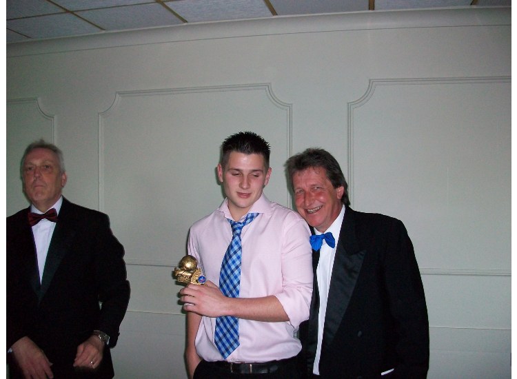 Chairman Tony Hurst (left) and Steve Laing (right) with the Reserves Players' Player of the Year: Michael Benning