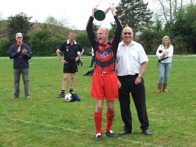 Dave Jeanes presented a delighted Sparky with the Premier Division Trophy