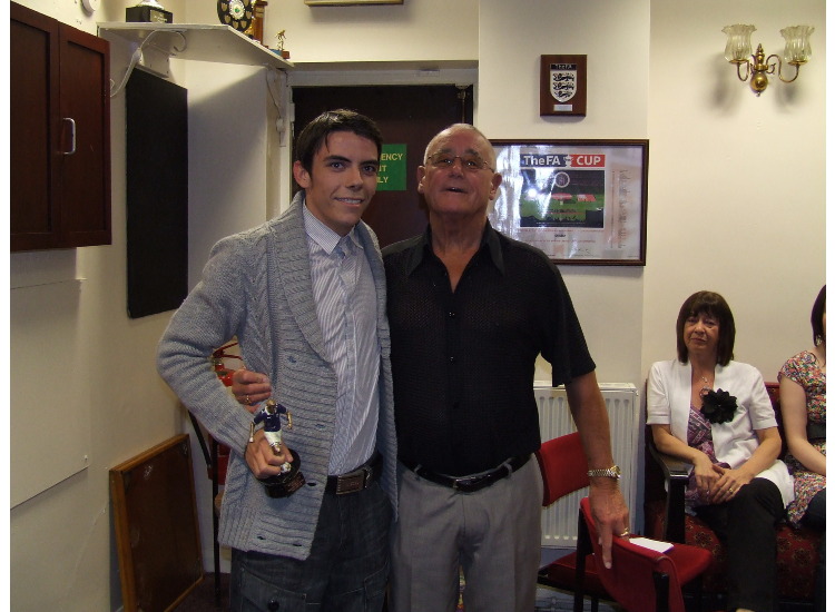 Sam Garvie receives the Supporters Player of the Year trophy from John Atkinson.