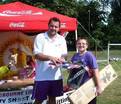 The penalty shoot prize draw winner, receiving his prizes from events Manager, Gavin Shearing.