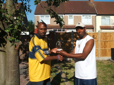 Seen here with Director of Football Colin Walton, Michael Oshineye has scored over 100 goals for the club over 16 years. He notched 21 goals during season 2005-06 for the second team in Division 3 at the ripe old age of **