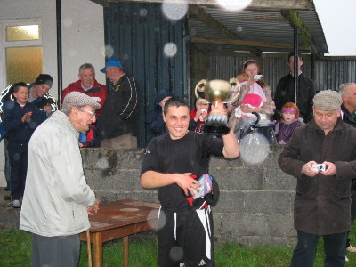 Captain Gwmba lifts the cup