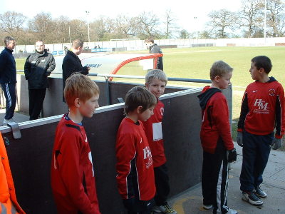 GEORGE,DANIEL AND SOME OF THE UNDER10s WAITING FOR THE PLAYERS TO MAKE AN APPEARANCE TO ENTER THE PITCH.