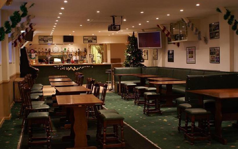 Comfortable seating area with soft lighting and widescreen TVs