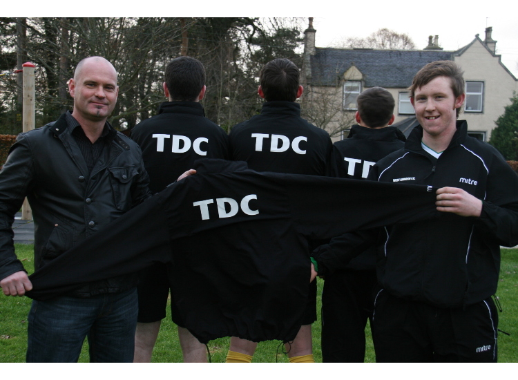 West Garioch captain Gordon Forsyth is presented with new tracksuits for the team by Kenny Pirie of sponsors TDC electrical and mechanical engineers, Bankhead, Aberdeen. (Picture: Ellice Milton) 
