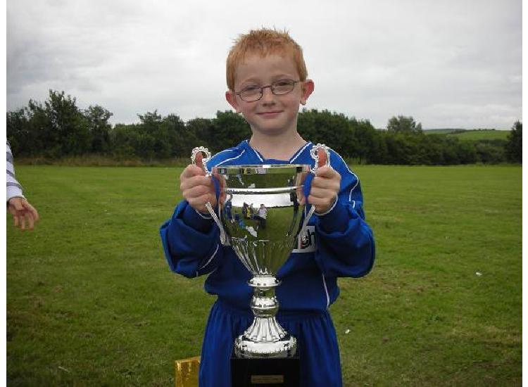 Cian holliday holding the Workington leisure cup