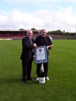 Tommy Cassidy receives a team of the month award from Witton Albion Chairman, Mike Worthington