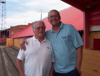 Wallace & Gromit - Director Jos Taylor and Barry Arnison (father of Gareth) in front of the new stand roof at Borough Park