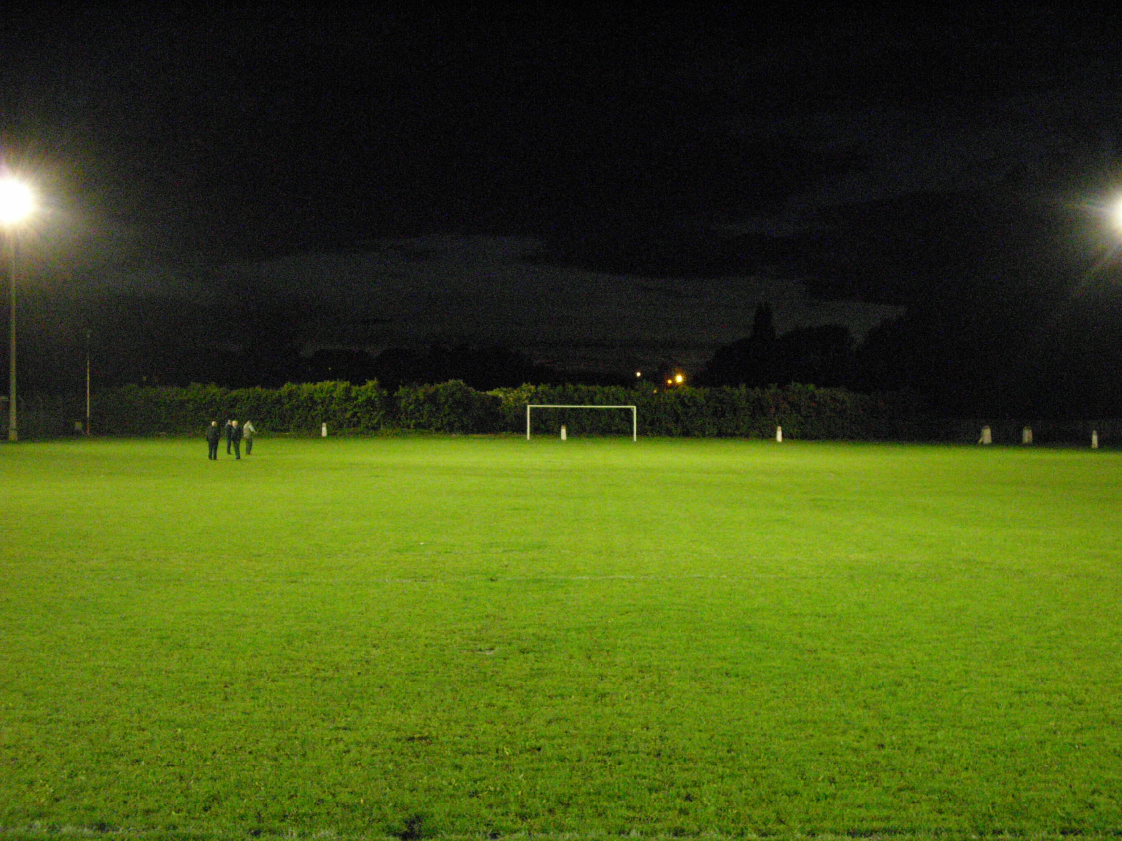 Behind the bottom goals